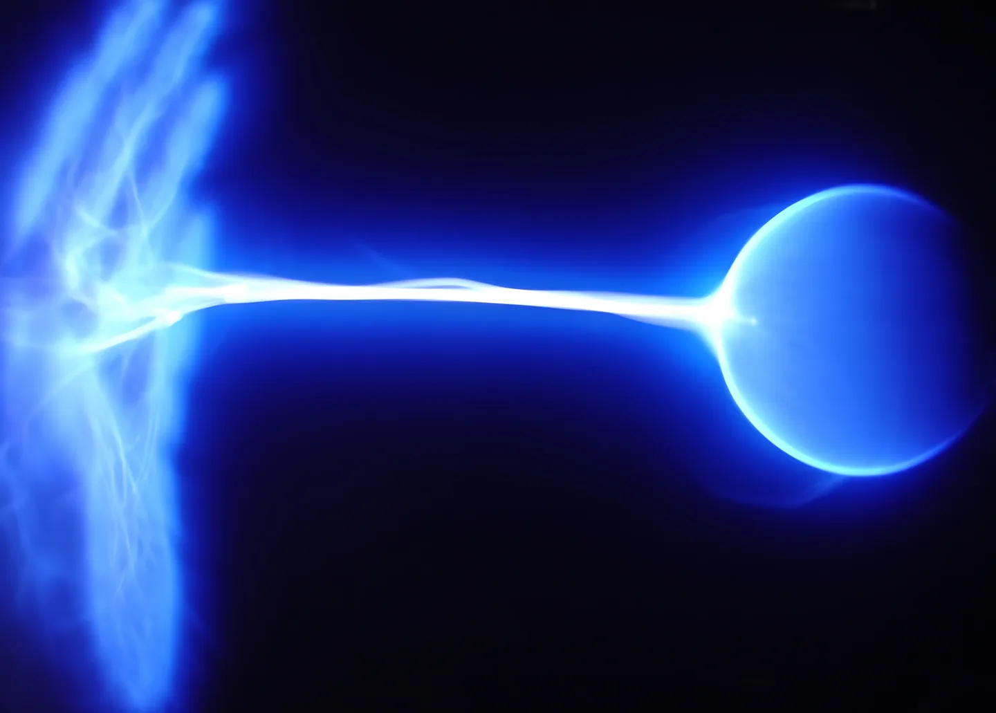 Blue plasma discharge against a dark background